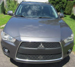 Front view of a 2011 Mitsubishi Outlander XLS in gray color, showcasing sleek design and modern features.