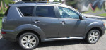 2011 Mitsubishi Outlander XLS FWD in grey, showcasing stylish side profile and alloy wheels.