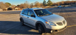 2006 Pontiac Vibe in silver color with custom tinting and new tires, parked in an empty lot.