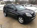 2011 GMC Acadia black SUV with new tires, heated seats, and towing package parked outside