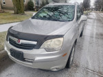 2009 Saturn VUE AWD silver SUV parked on a snowy street, showing minor dings and clean front seats.