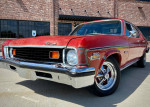 1973 Chevrolet Nova Custom Sedan with 350 engine, showcasing a classic red exterior, parked outside.