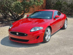 2014 Jaguar XKR Coupe in red, showcasing immaculate condition with sleek design and performance features.