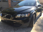 Front view of a 2010 Volvo C30 in black with Sparco wheels, showcasing its design and condition.