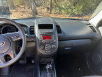 Interior view of a well-maintained 2013 Kia Soul with a functional dashboard and audio system