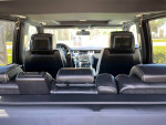 Interior view of a 2009 Land Rover Range Rover Supercharged, featuring black leather seats and headrest TVs.