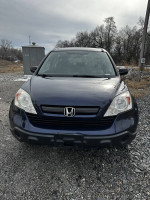 Front view of a 2009 Honda CR-V in good condition, with excellent paint and all-wheel drive features.