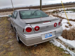 1999 Chevrolet Blazer in brown, showing rear, parked on grassy area with snow