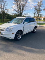 2012 Chevrolet Captiva Sport V6 SUV in white parked by a lake, showcasing its immaculate condition.