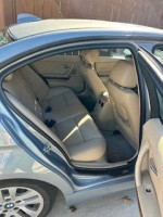 Interior view of a 2007 BMW 328I with beige seats and ample rear space for passengers.