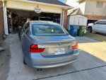 2007 BMW 328I parked in a driveway, showing rear view with garage in background