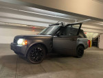 2006 Land Rover Range Rover with striking matte finish parked indoors, showcasing sleek design and modern wheels.