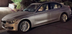 2015 BMW 328d in orion-silver with beige leather interior parked at night