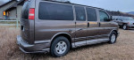 2004 Chevrolet Express 1500 AWD van with leather interiors and family-friendly features, parked in a grassy area.