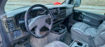 Interior view of a 2004 Chevrolet Express 1500 AWD with leather seats and modern dashboard features.