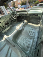 Interior view of a 1964 Chevy Impala SS project car, showcasing clean frame and original front seats.