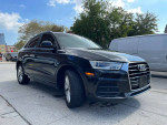 2017 Audi Q3 Premium in black parked on the street, showcasing its sleek design and modern features.