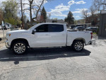 2021 Chevrolet Silverado 1500 LT 4WD in pristine condition, parked on a sunny day with clear skies.