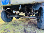 Under view of a 1989 Chevy Suburban showing 2500 axles and lifted suspension with adjustable manual hubs.