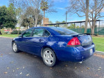 2006 Chevrolet Impala SS in blue color parked outdoors, showcasing its sleek design and leather interior