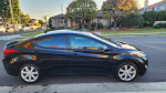 2013 Hyundai Elantra Limited black sedan parked on the street with clean bodywork and sunny surroundings