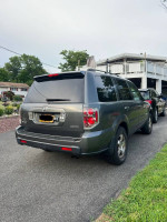 2007 Honda Pilot EX-L FWD parked in driveway, 51,000 miles, grey SUV with minor dings and scratches.