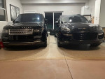 Black Land Rover Range Rover parked in a garage, showcasing its luxurious design and elegance.