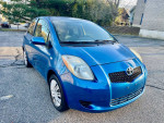 2007 Toyota Yaris in blue, automatic hatchback with 62,000 miles, in excellent condition, parked outdoors.