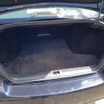 Trunk space of a 2007 Infiniti M35 RWD with fresh carpet and spacious design.