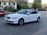 2010 BMW 5 Series 528i sedan parked on the street, showcasing its exterior and design.