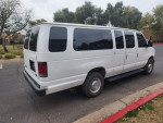 2004 Ford E-350 12 passenger van shown from the rear, clean and well-maintained, ideal for families or businesses.