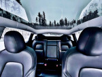 Interior view of a 2021 Tesla Model Y showcasing leather seats and panoramic roof.