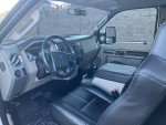 Interior view of a clean 2008 Ford F250 Super Duty with leather power seats and modern dashboard features.