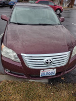 2008 Toyota Avalon in maroon, showing clean exterior and license plate, parked in a lot.