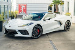 2022 Chevrolet Corvette Stingray in Arctic White with red leather interior, showcasing performance features and sleek design.