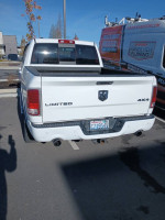 2014 Ram 1500 Limited 4x4 truck with a short bed and crew cab parked in a lot