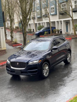 Luxury Jaguar F-PACE parked in a residential area, showcasing sleek design and premium features.