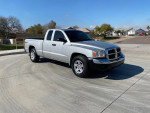2005 Dodge Dakota SLT 4X4 with 59K miles parked on a sunny street.