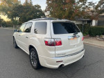 2011 GMC Acadia Denali FWD in white, showcasing its great condition and design, parked on a suburban street.