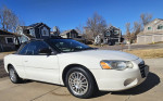 2006 Chrysler Sebring Convertible in white with new transmission, parked in a residential area.