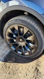 Close-up of oversized black 20-inch wheel on a 2023 Tesla Model Y in excellent condition