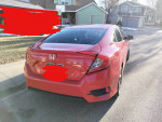 2016 Honda Civic EX in Rallye Red parked on a residential street, showcasing its sleek design