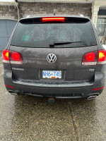 Rear view of a 2010 Volkswagen Touareg TDI, showing clean condition and features like backup camera and tow hitch.
