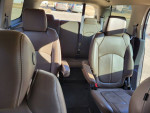 Interior of a 2015 GMC Acadia showcasing comfortable leather seats and spacious rear seating area.
