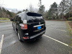 2019 Lexus GX 460 4WD parked in a spacious lot, showcasing its polished black exterior and immaculate condition.