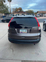 Rear view of a 2013 Honda CR-V EX AWD parked, showcasing its clean design and license plate.