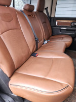 Interior seating of a 2014 Ram 2500 Laramie 4WD with leather upholstery and spacious design.