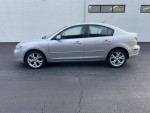 Silver Mazda 3 with 102,000 miles, low mileage, clean condition, parked on asphalt