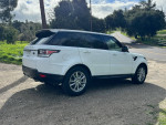 2016 Land Rover Range Rover Sport in Fuji White parked on a rural road, showcasing its third row seating and panoramic roof.