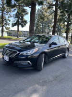 2015 Hyundai Sonata Eco FWD in excellent condition with alloy wheels, parked under trees.
